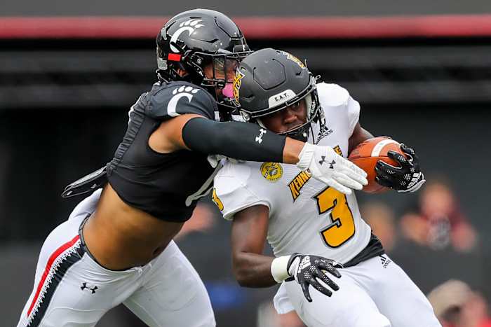 Sep 10, 2022; Cincinnati, Ohio, USA; Kennesaw State Owls running back Nykeem Farrow (3) runs with the ball against Cincinnati Bearcats linebacker Ivan Pace Jr. (0) in the first half at Nippert Stadium. Mandatory Credit: Katie Stratman-USA TODAY Sports